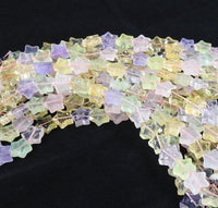 Prehnite, Amethyst, Rose Quartz, and Citrine bead strand on a black backdrop