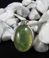 Prehnite stone on a black backdrop