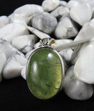 Prehnite stone on a black backdrop