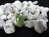 Prehnite stone on a black backdrop