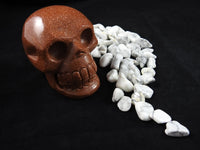 Goldstone Crystal Skull sitting in Howlite