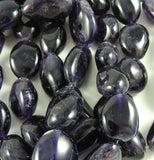 Amethyst beads on white backdrop